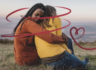 Couple hugging with red thread around them