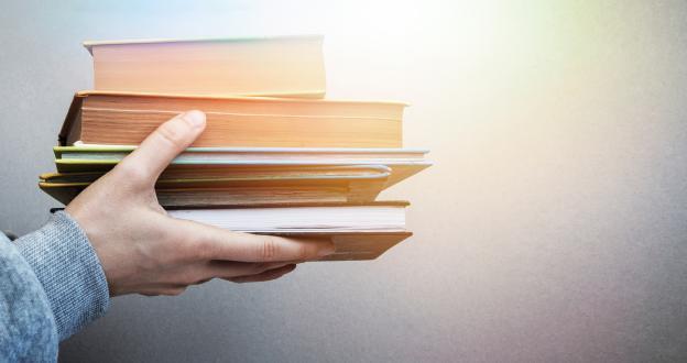 Hands holding books